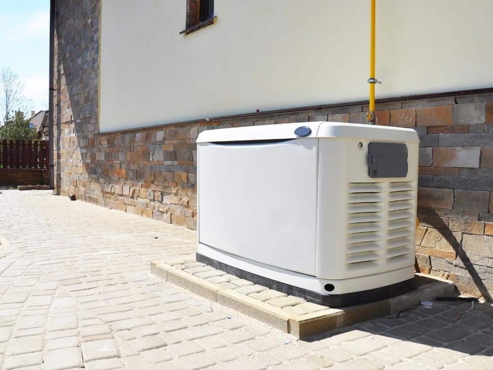Generator in a yard next to a house